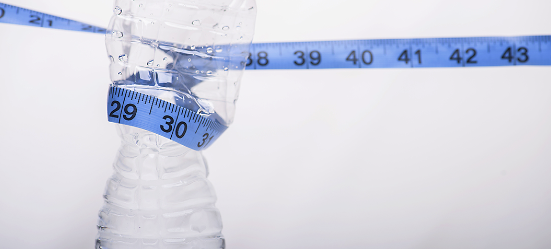 water bottle with measuring tape around it